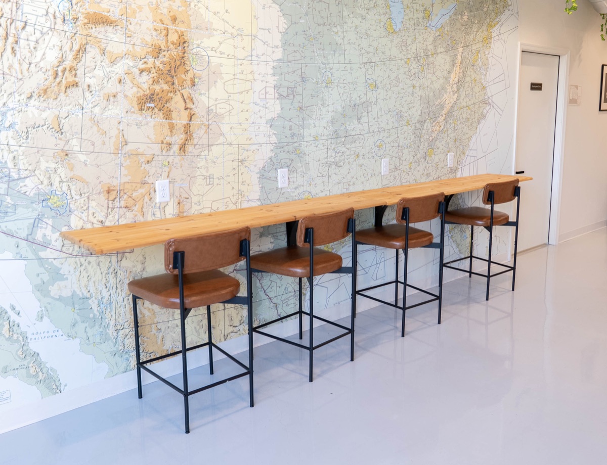 A high-top study bar along a wall-sized aeronautical chart