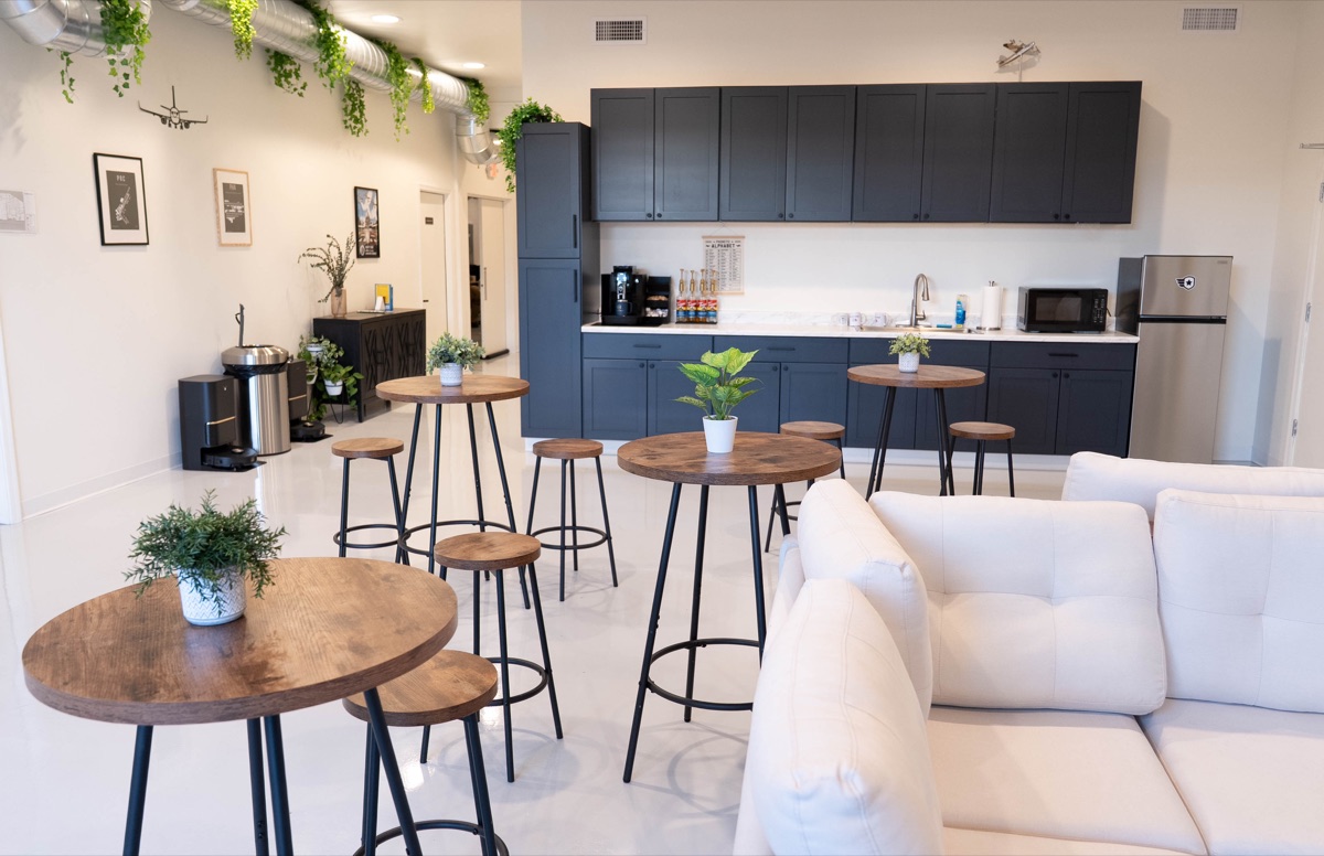 The student kitchen with a fridge, microwave, sink and coffee machine