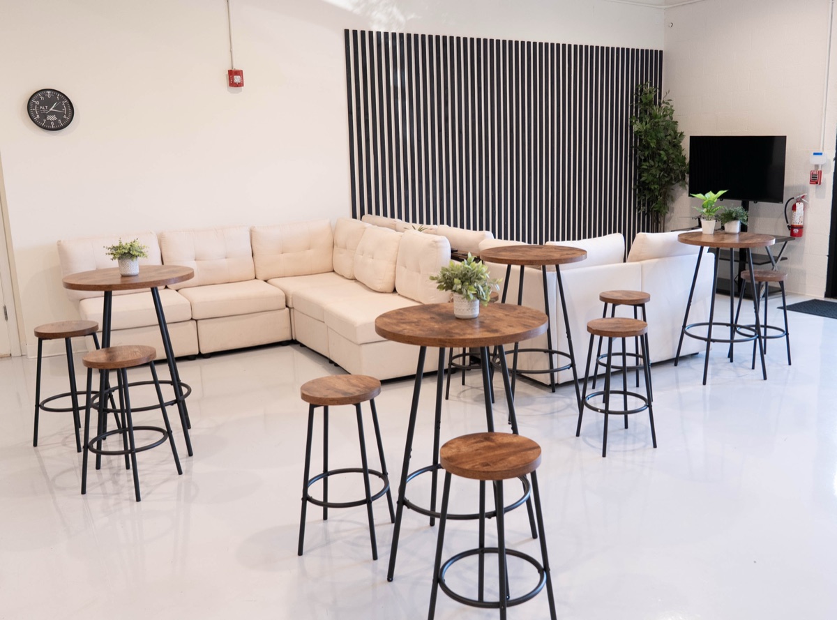 The student lounge with a sectional sofa and high-top tables