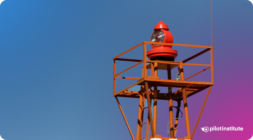 Airport beacon structure with a red rotating light on a metal tower.