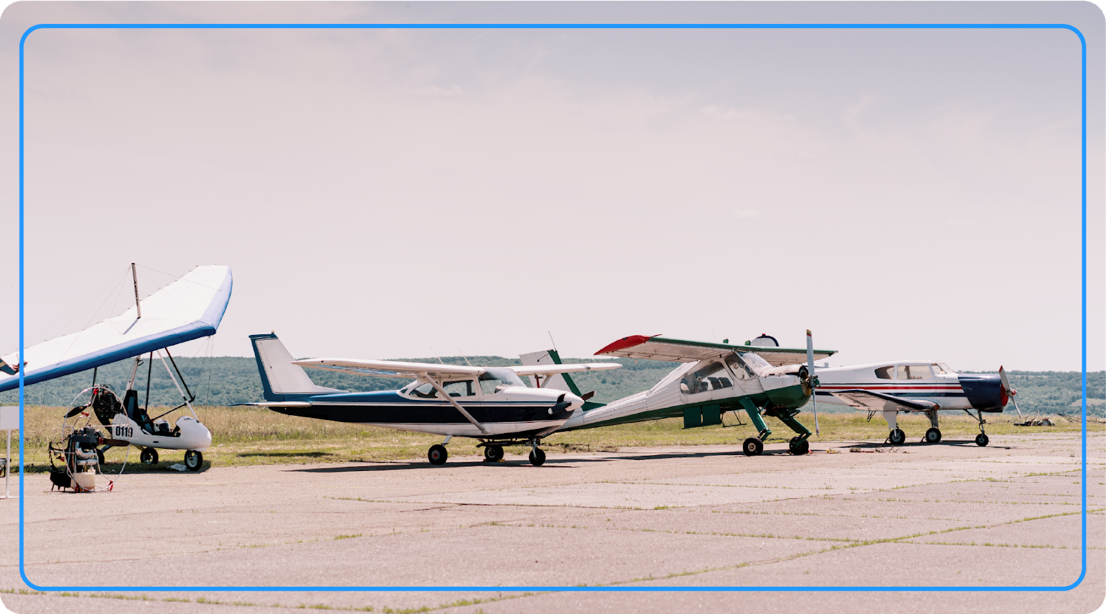 General aviation aircraft lined up at a small airport.