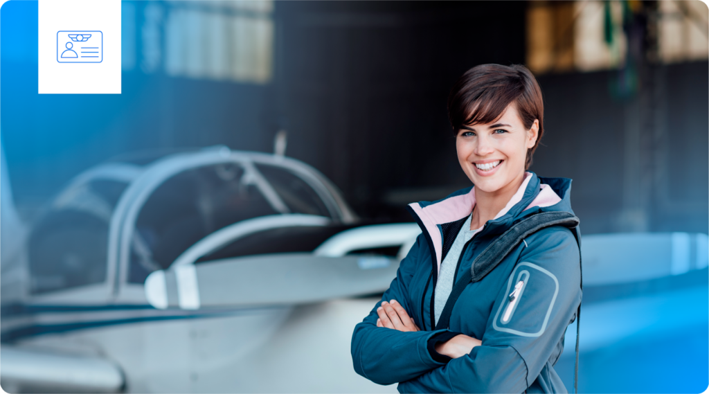 A woman stands in front of a training airplane.