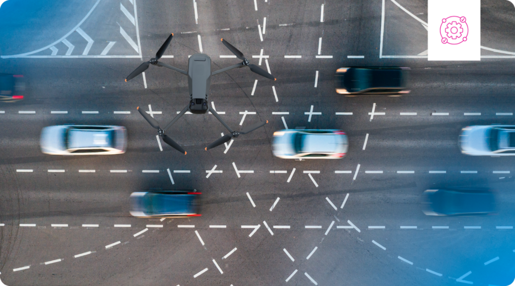 A drone hovers over a busy road.