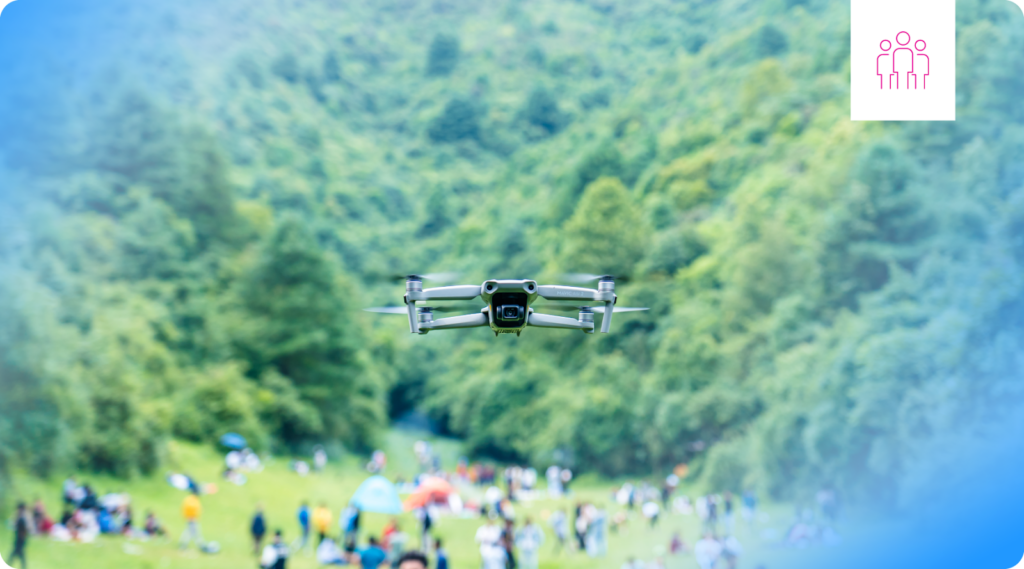 A drone operating over a crowd of people.