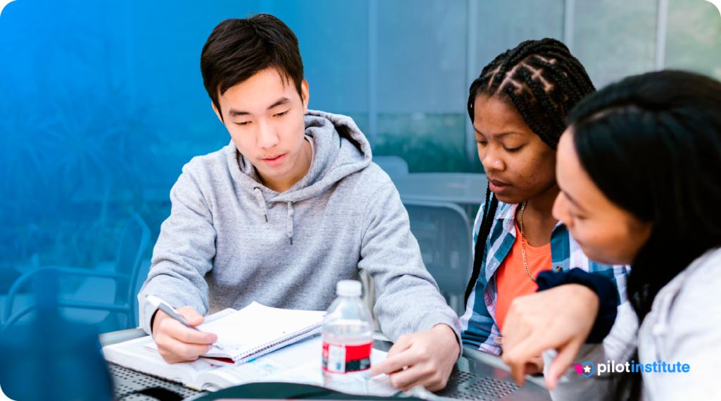 Group of students studying together at a table with notes and books. Pilot Institute logo included.