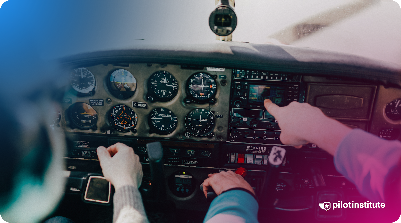 Student pilot and instructor in a general aviation cockpit, pointing at avionics and instruments during flight training.